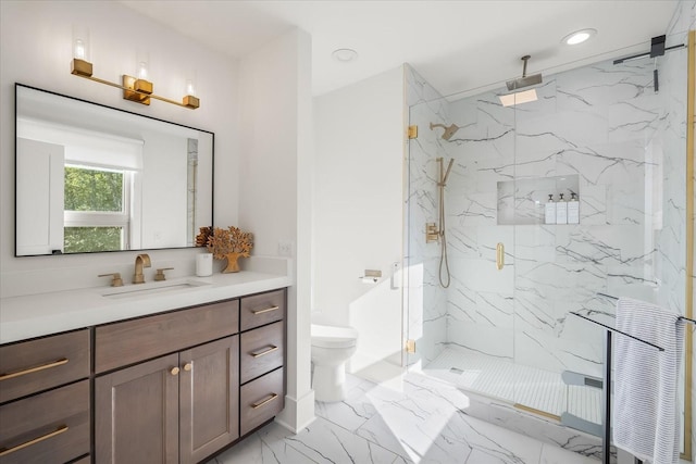 bathroom with a shower with door, vanity, and toilet