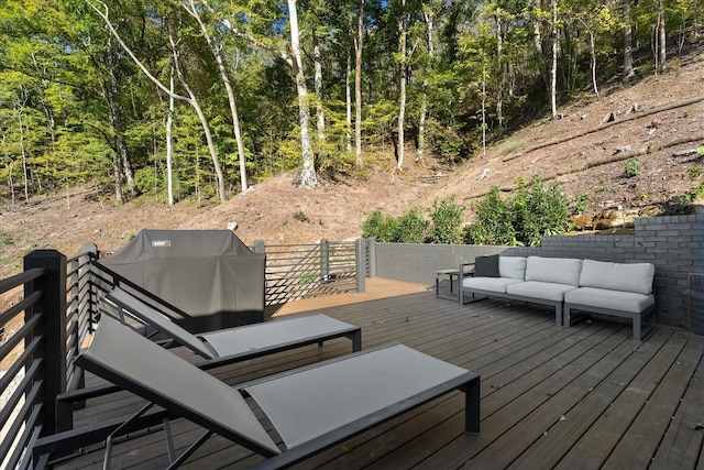 wooden deck with outdoor lounge area and grilling area