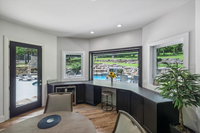 interior space featuring wine cooler and light hardwood / wood-style flooring