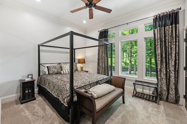 carpeted bedroom featuring multiple windows, ceiling fan, and ornamental molding