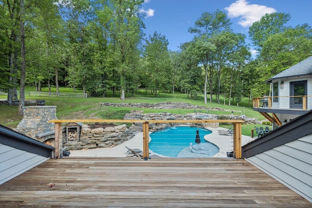 view of pool with a deck and a yard