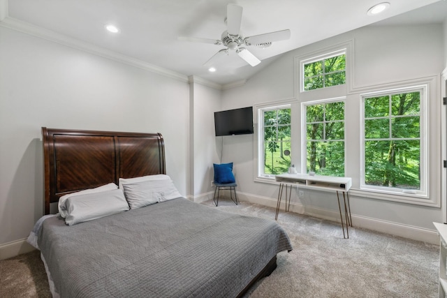 bedroom with ceiling fan, light colored carpet, lofted ceiling, and multiple windows