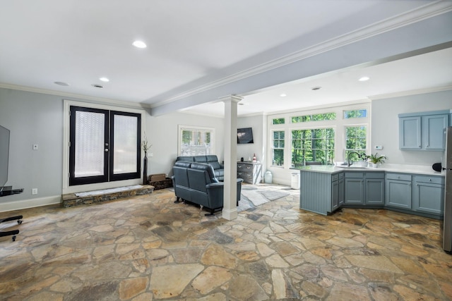 living room with sink, ornate columns, crown molding, and french doors