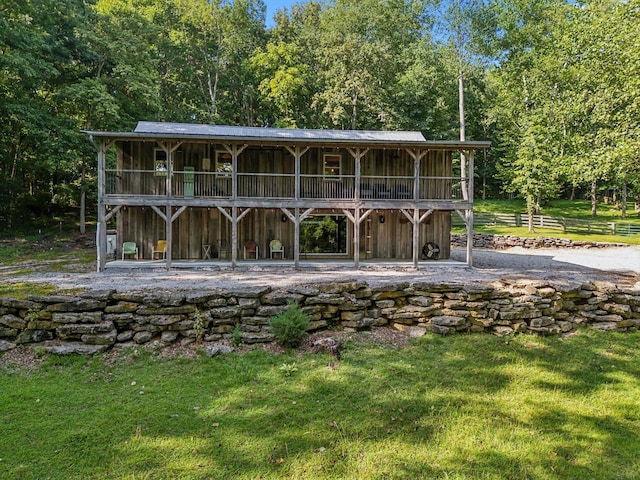 back of property with a yard and a wooden deck