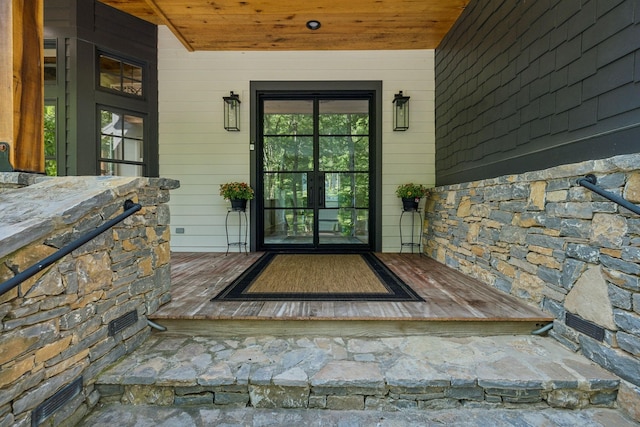 view of exterior entry featuring a porch