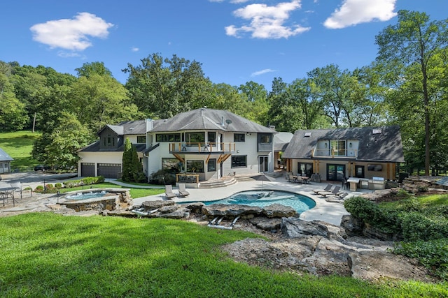 view of pool with a patio, a hot tub, and a lawn