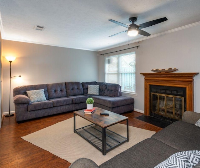 living room with dark hardwood / wood-style flooring, ceiling fan, and ornamental molding