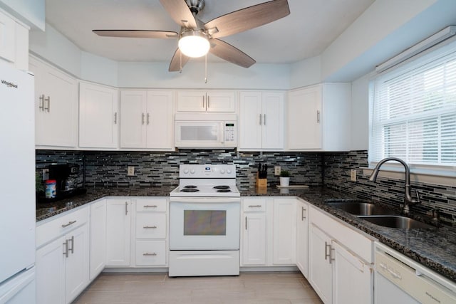 kitchen with decorative backsplash, white cabinetry, sink, and white appliances