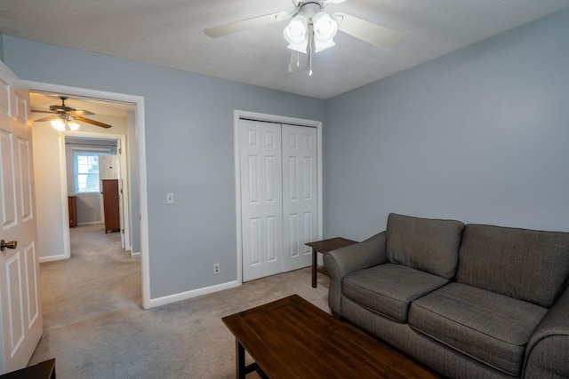 carpeted living room featuring ceiling fan