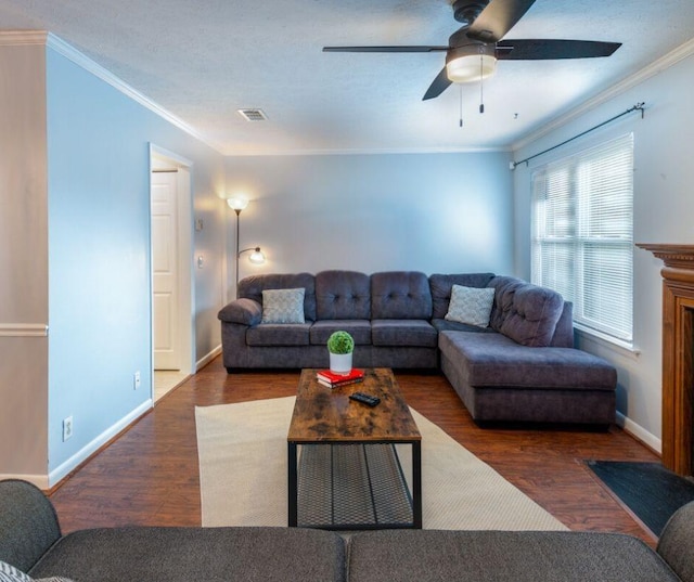 living room featuring dark hardwood / wood-style floors, ceiling fan, and crown molding