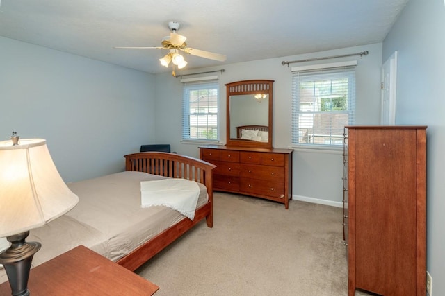 carpeted bedroom with multiple windows and ceiling fan