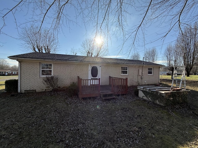 back of property featuring a wooden deck