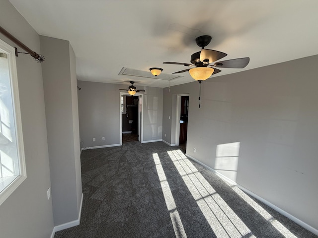 carpeted spare room with ceiling fan