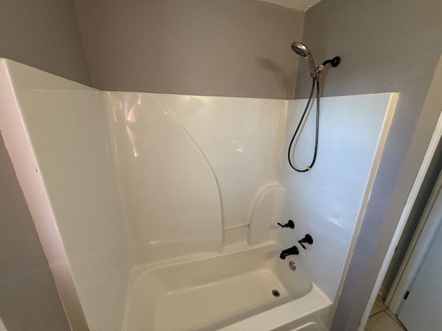 bathroom featuring tile patterned flooring and  shower combination