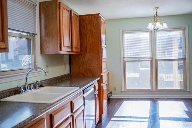 kitchen featuring dishwasher, decorative light fixtures, a notable chandelier, and sink