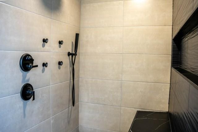 bathroom with a tile shower