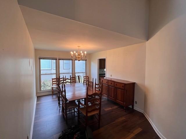 dining room with a notable chandelier and dark hardwood / wood-style floors