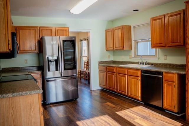 kitchen featuring sink, black appliances, and dark hardwood / wood-style floors