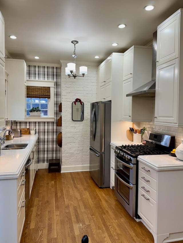 kitchen with white cabinets, stainless steel appliances, hanging light fixtures, and sink