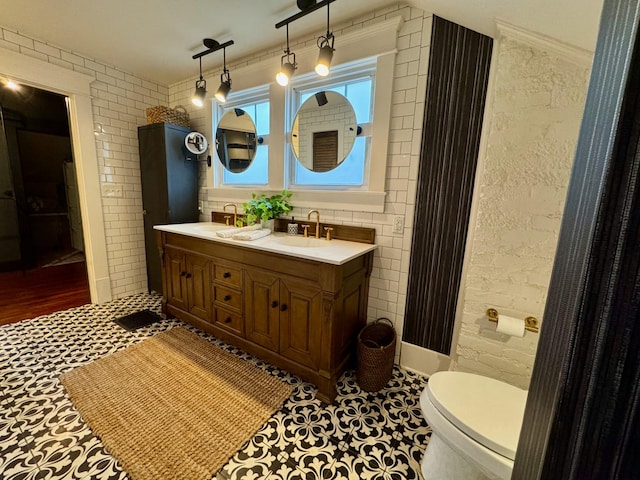 bathroom with tile patterned flooring, vanity, and toilet