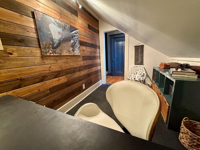 interior space with wooden walls and vaulted ceiling