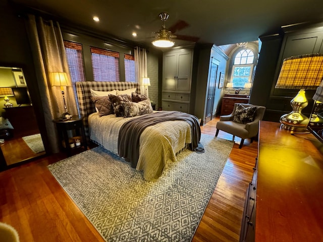 bedroom featuring ceiling fan and dark wood-type flooring