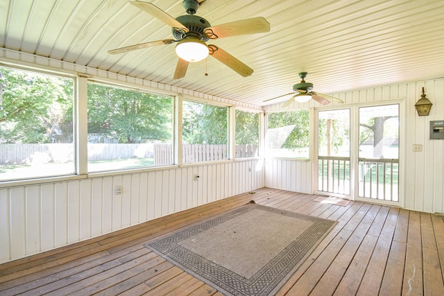 unfurnished sunroom with ceiling fan