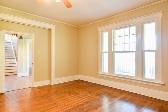 unfurnished room with wood-type flooring, ceiling fan, and ornamental molding