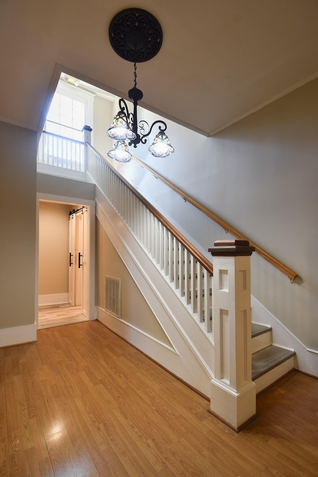 staircase with hardwood / wood-style flooring