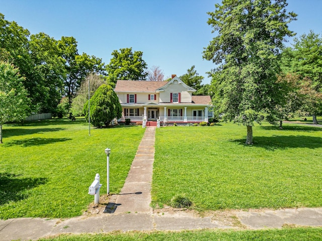 view of front of property featuring covered porch and a front yard