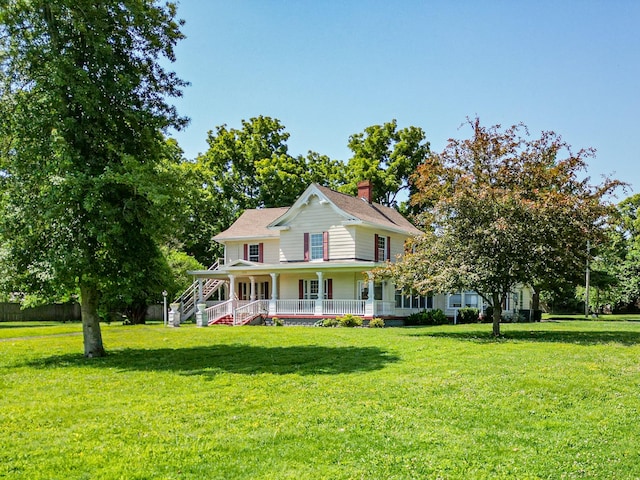 farmhouse with covered porch and a front yard