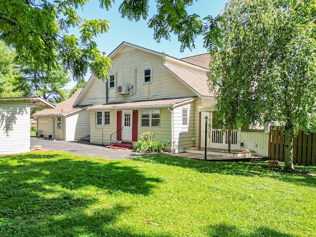 rear view of house with a yard