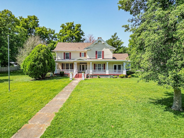 view of front of house featuring covered porch and a front yard