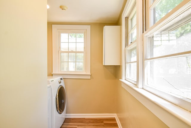 washroom featuring washer / clothes dryer, crown molding, and light hardwood / wood-style floors