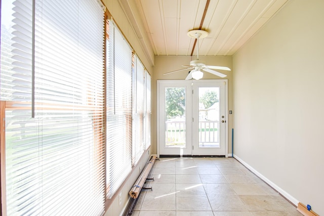 entryway with ceiling fan and light tile patterned flooring