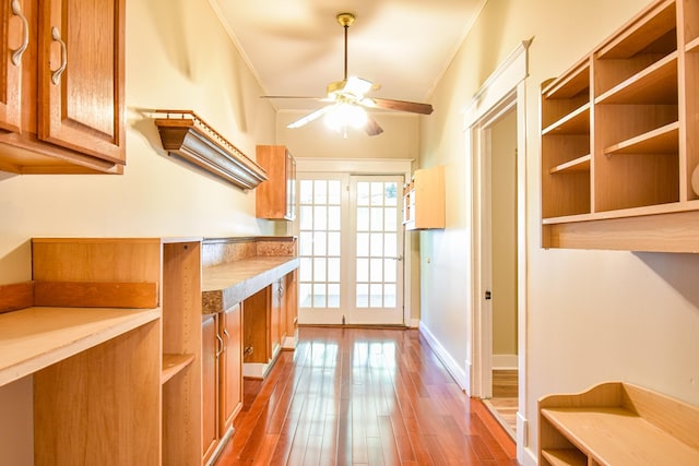 kitchen featuring crown molding, ceiling fan, and wood-type flooring