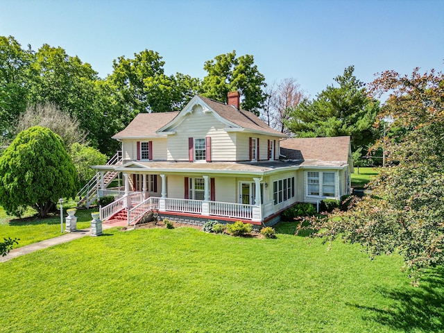 farmhouse featuring a porch and a front lawn