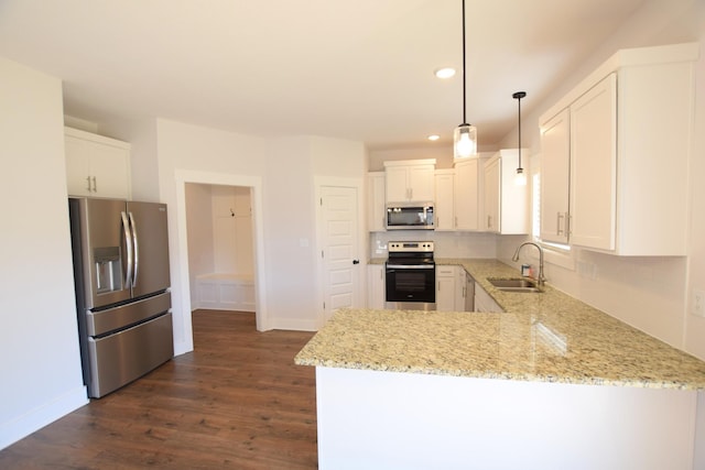 kitchen with kitchen peninsula, white cabinetry, stainless steel appliances, and hanging light fixtures