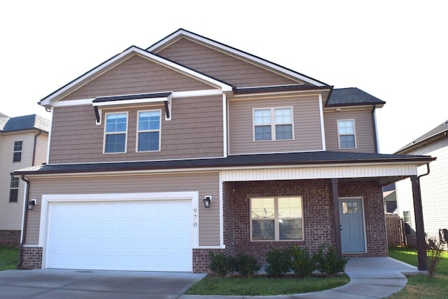 view of front of home with covered porch and a garage