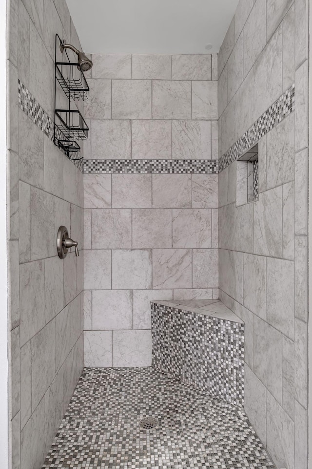 bathroom with a tile shower