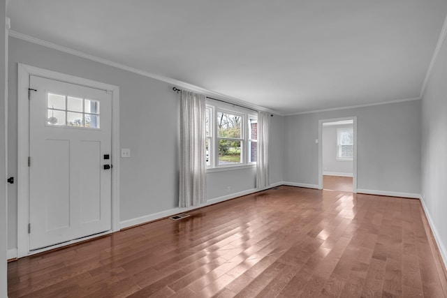 entryway featuring light hardwood / wood-style floors, ornamental molding, and a wealth of natural light