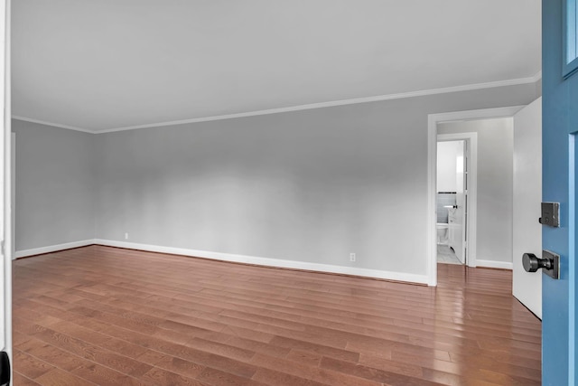 unfurnished room featuring ornamental molding and hardwood / wood-style flooring