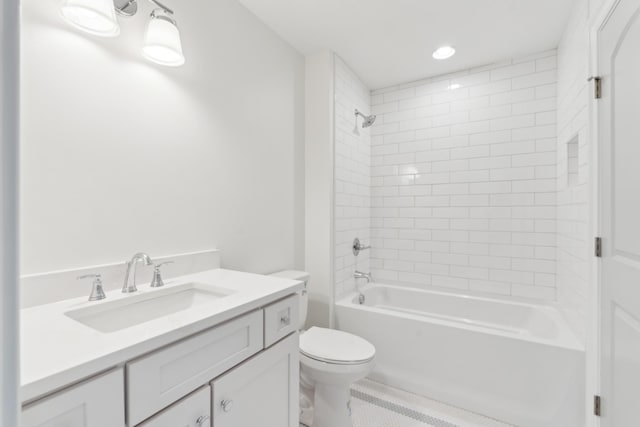 full bathroom with tiled shower / bath combo, toilet, and vanity