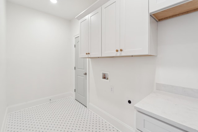 clothes washing area with cabinets and hookup for a washing machine