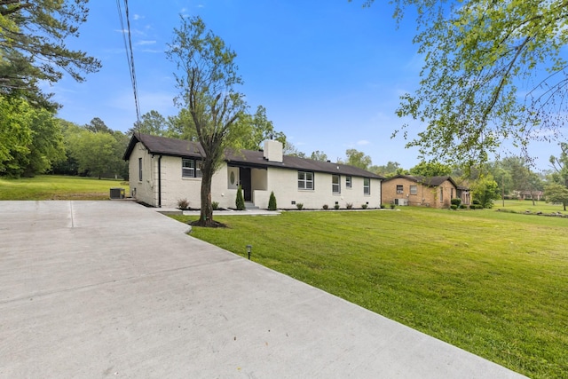 ranch-style home with a front yard and cooling unit