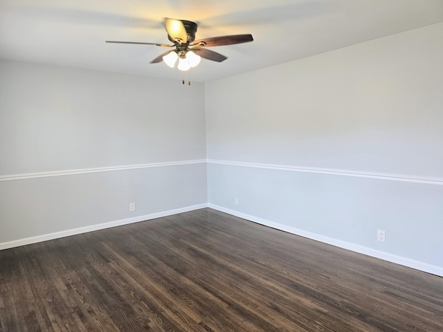 unfurnished room with ceiling fan and dark wood-type flooring