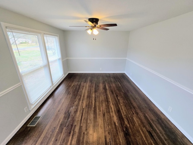 spare room featuring ceiling fan and dark hardwood / wood-style floors