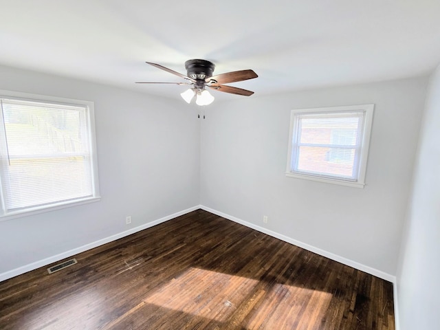 empty room featuring dark hardwood / wood-style floors and ceiling fan