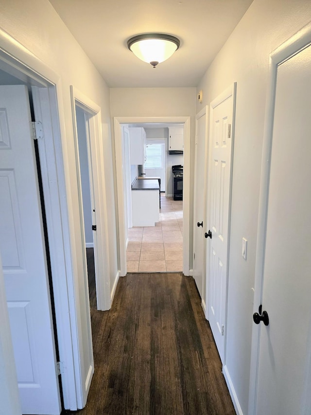 hallway with hardwood / wood-style floors