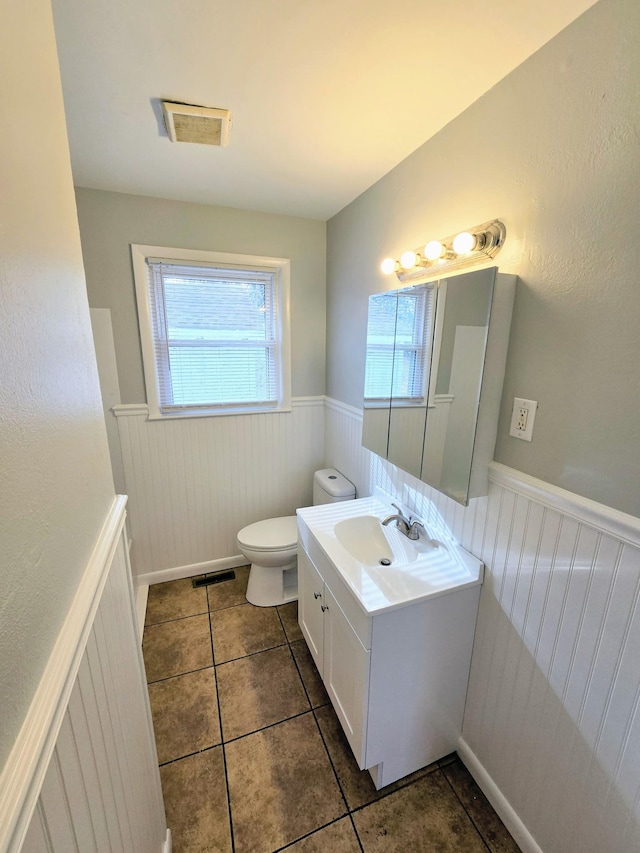 bathroom with tile patterned flooring, vanity, and toilet